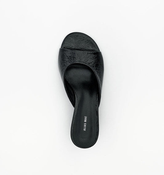 Top view of the black leather mule showing the rounded open toe, wide front strap and slip-on footbed.