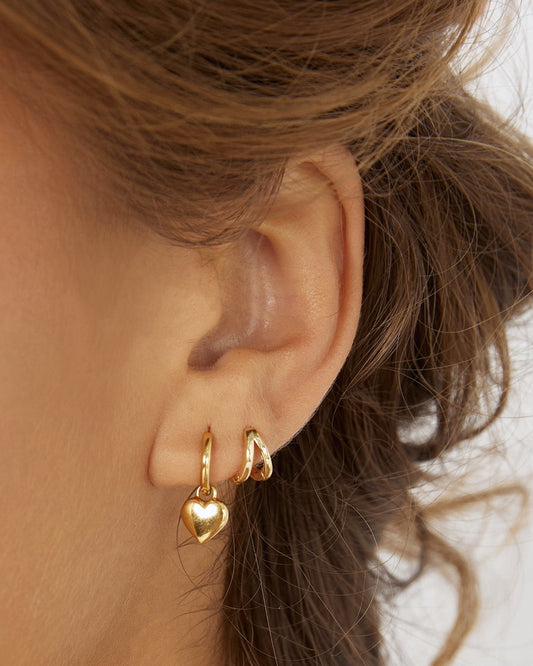 Arms Of Eve Treasure Gold Earrings worn in a layered gold earring stack.