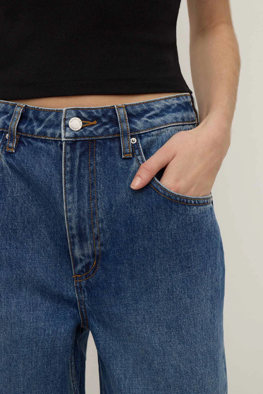 Assembly Label Low Curve Jeans in Mid Blue — the Assembly Label Low Curve Jeans in Mid Blue offer a relaxed take on everyday denim with a contemporary curved-leg silhouette.