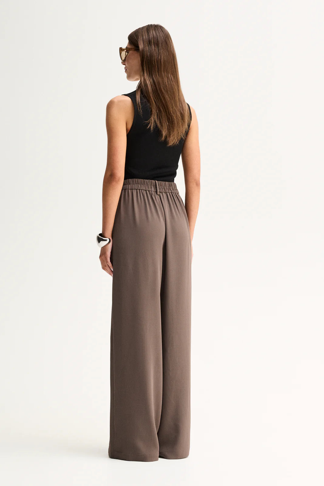 Elka Collective Fleur Pants in Taupe, full-length back view on model.
