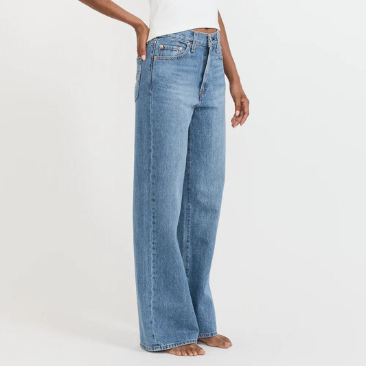Light blue jeans worn by a person on a white background
