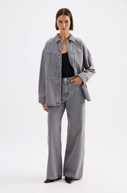 A model wears the Steel Calvi Boyfriend Jean with a matching grey denim shirt in a full-length studio view.