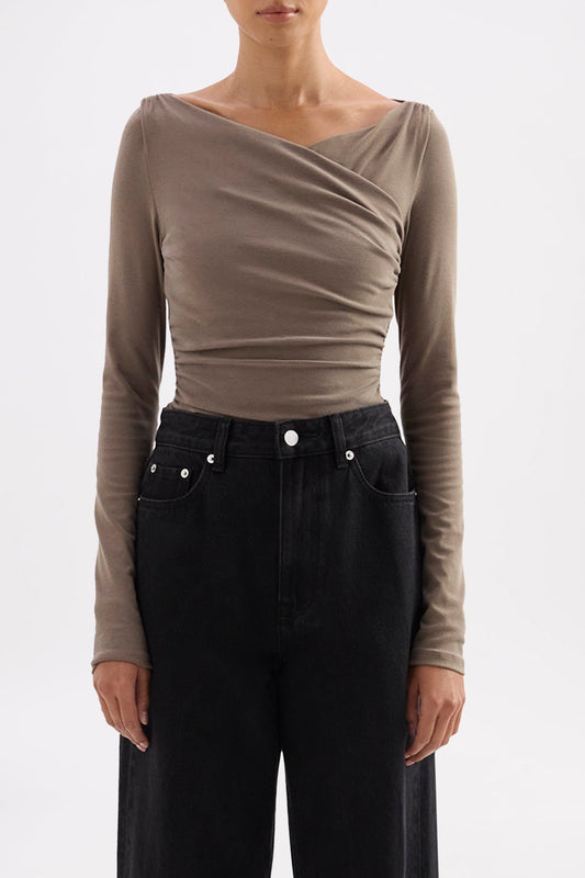 Close front view of the fitted truffle top showing the softly draped neckline and gathered waist.