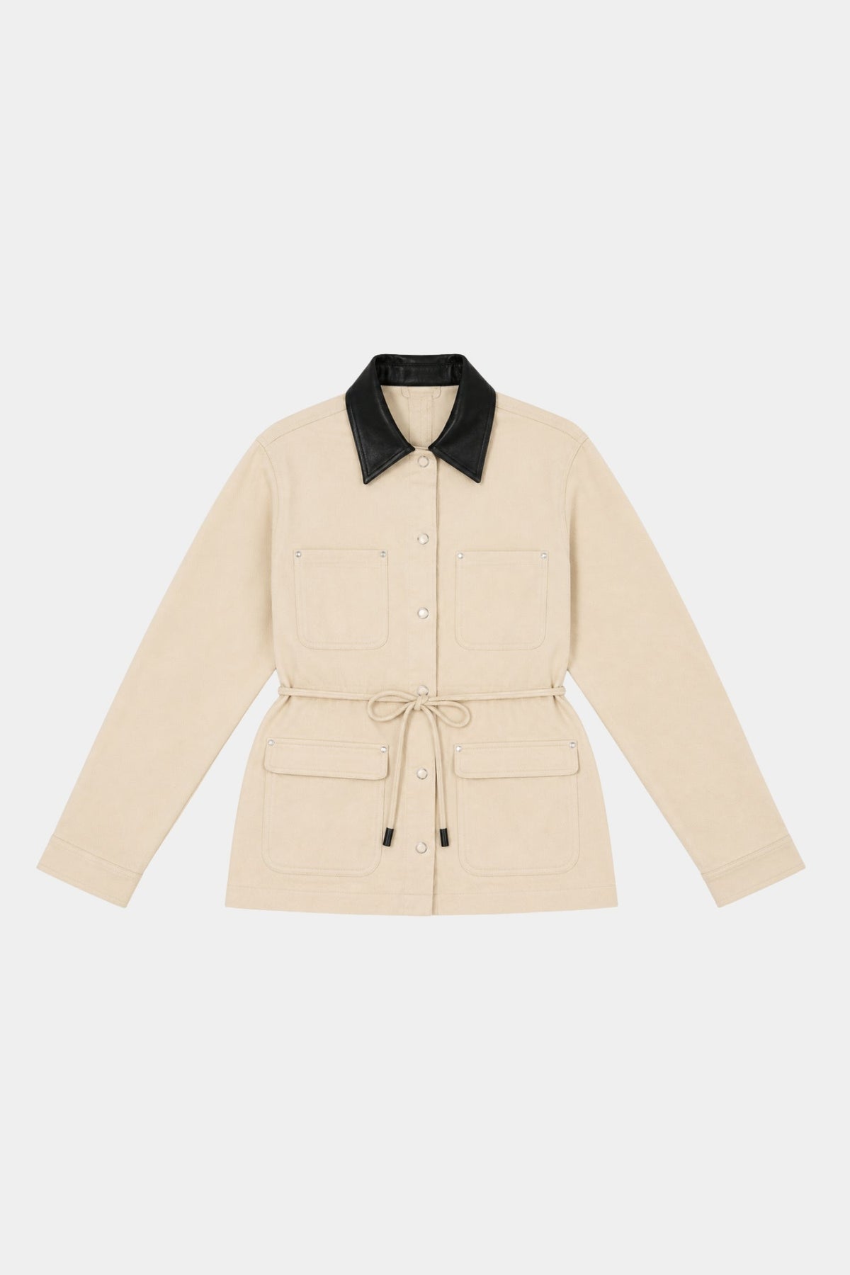 Beige Idris Jacket laid flat on a white background, showing the black contrast collar, long sleeves, front closure, patch pockets and detachable waist tie
