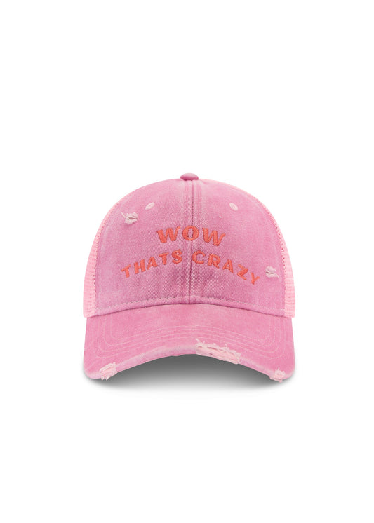 Front product view of the pink trucker cap highlighting the curved embroidered slogan and distressed detailing against a white background.