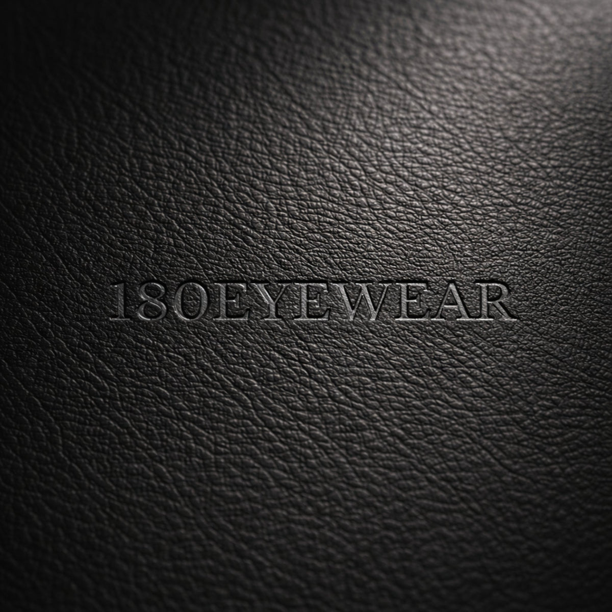 Close-up of a black textured sunglasses case embossed with the 180EYEWEAR logo.