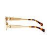 Side profile view of the 180EYEWEAR 'Isla' sunglasses in gold with brown lenses, showing the slim metal temple arm and tortoiseshell tip.