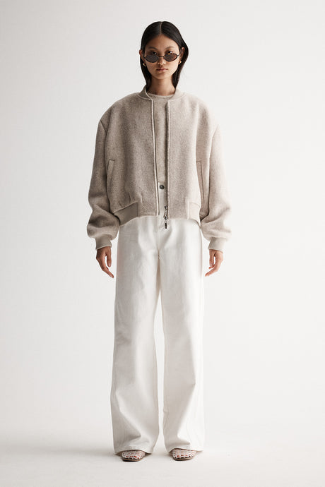 Elka Collective’s Nonnie Jacket is a cropped wool-blend bomber with an oversized fit, ribbed trim, and double zip—perfect for laid-back styling.