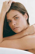 Editorial portrait of a model wearing the Porter Oval Studs 1CT in Silver on the ear