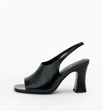 A single black leather slingback high-heeled sandal with an open toe, shown from a side profile on a clean white background.