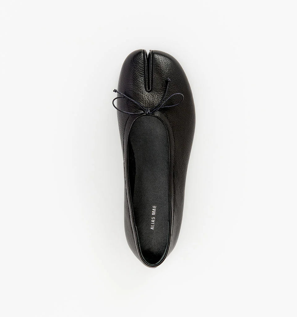 Alias Mae Lana Tabi Ballet Flat in Black Tumble, top view showing the split toe and bow detail.
