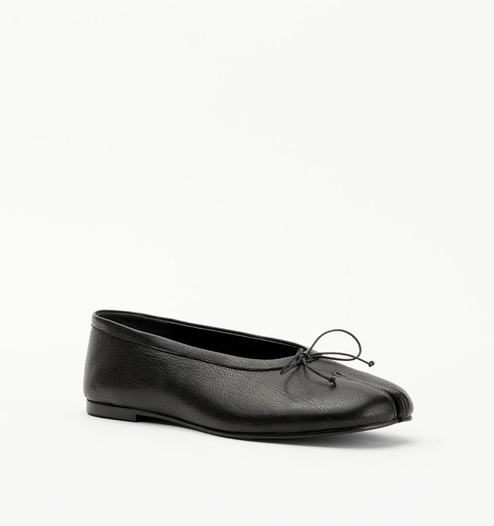 Alias Mae Lana Tabi Ballet Flat in Black Tumble, angled front view showing the split toe and bow detail.
