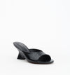 Three-quarter front view of the black crinkle leather mule highlighting the open toe and curved wedge heel.