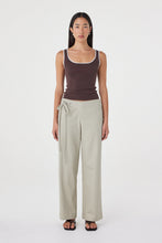 Model wearing the espresso tank with cream tailored trousers, showing the square scoop neckline, wide straps, contrast cream trim and close-fitting shape in a full-length front view.
