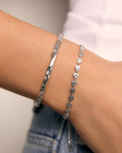 Arms Of Eve Atlas Silver Bracelet, styled on the wrist with a silver cuff.
