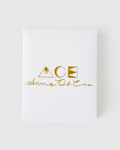 White towel with gold logo and text on a white background