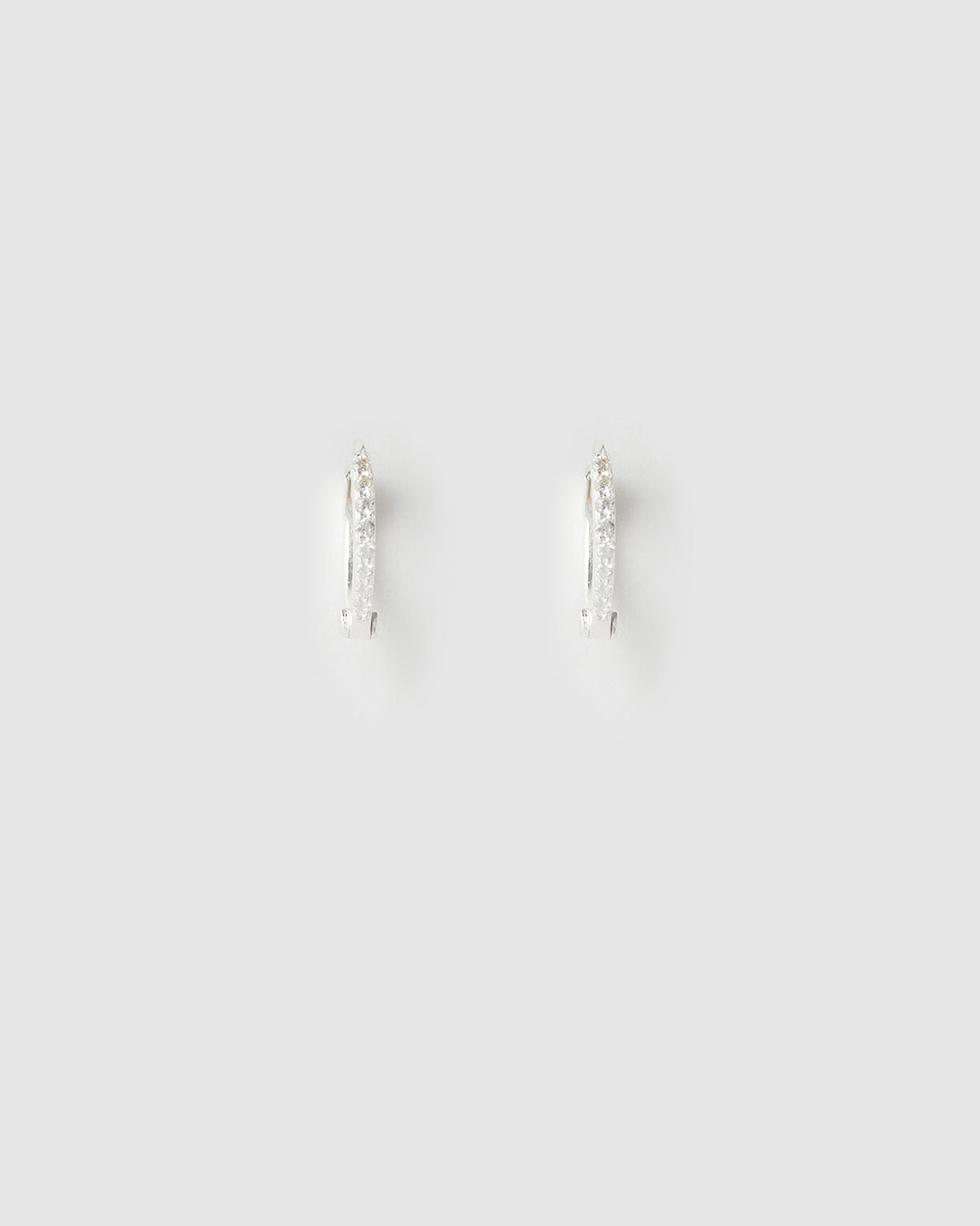 Pair of silver hoop earrings on a light gray background
