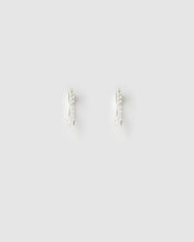 Pair of silver hoop earrings on a light gray background