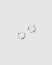 Two silver hoop earrings on a light gray background