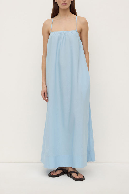 Model wearing the Salt Celine Tie Back Dress with black sandals, showing the straight neckline, thin shoulder straps and relaxed full-length maxi silhouette, front view
