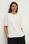 Close-up front view of an antique white short-sleeve tee showing its relaxed shape, crew neckline and sleeve construction.
