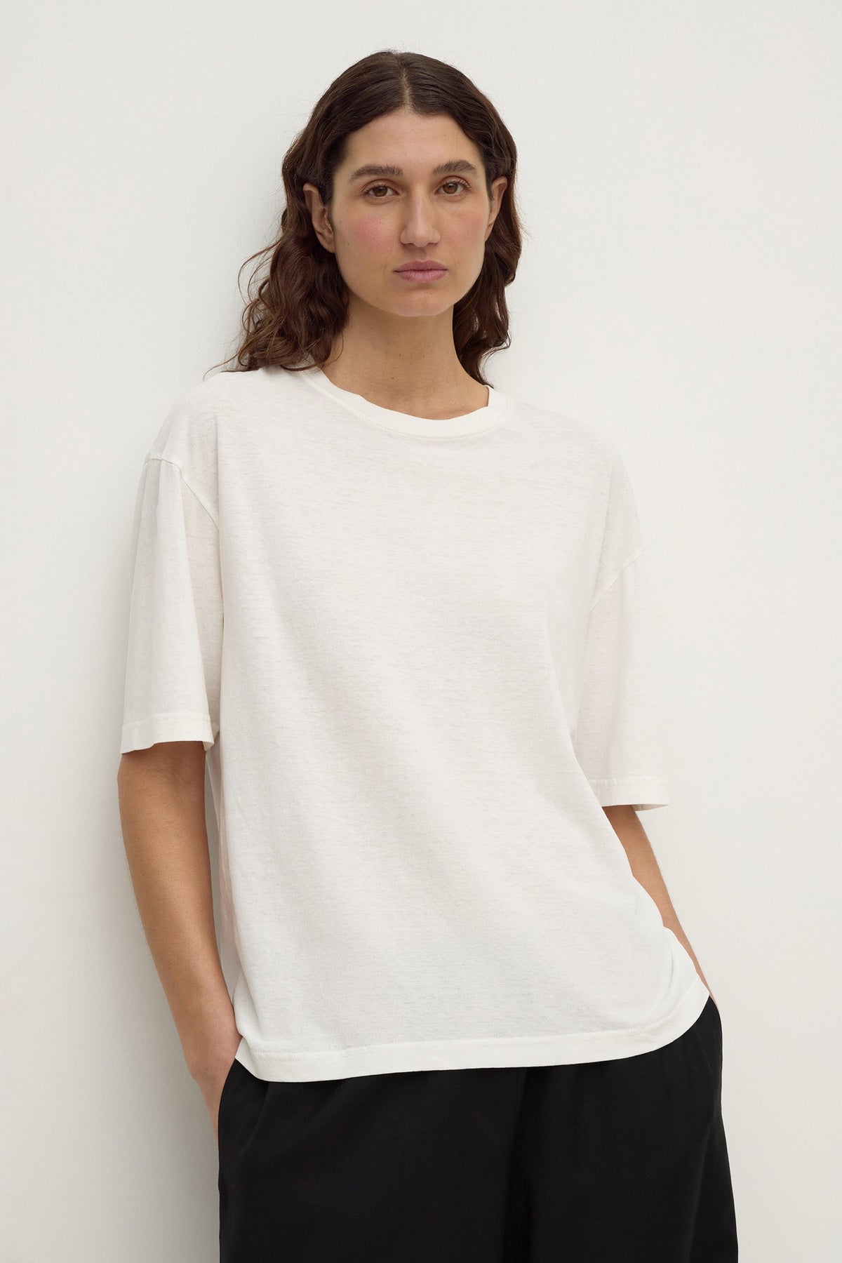 Close-up front view of an antique white short-sleeve tee showing its relaxed shape, crew neckline and sleeve construction.
