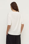 Back view of an antique white short-sleeve tee showing the plain back, relaxed boxy silhouette and straight hem.