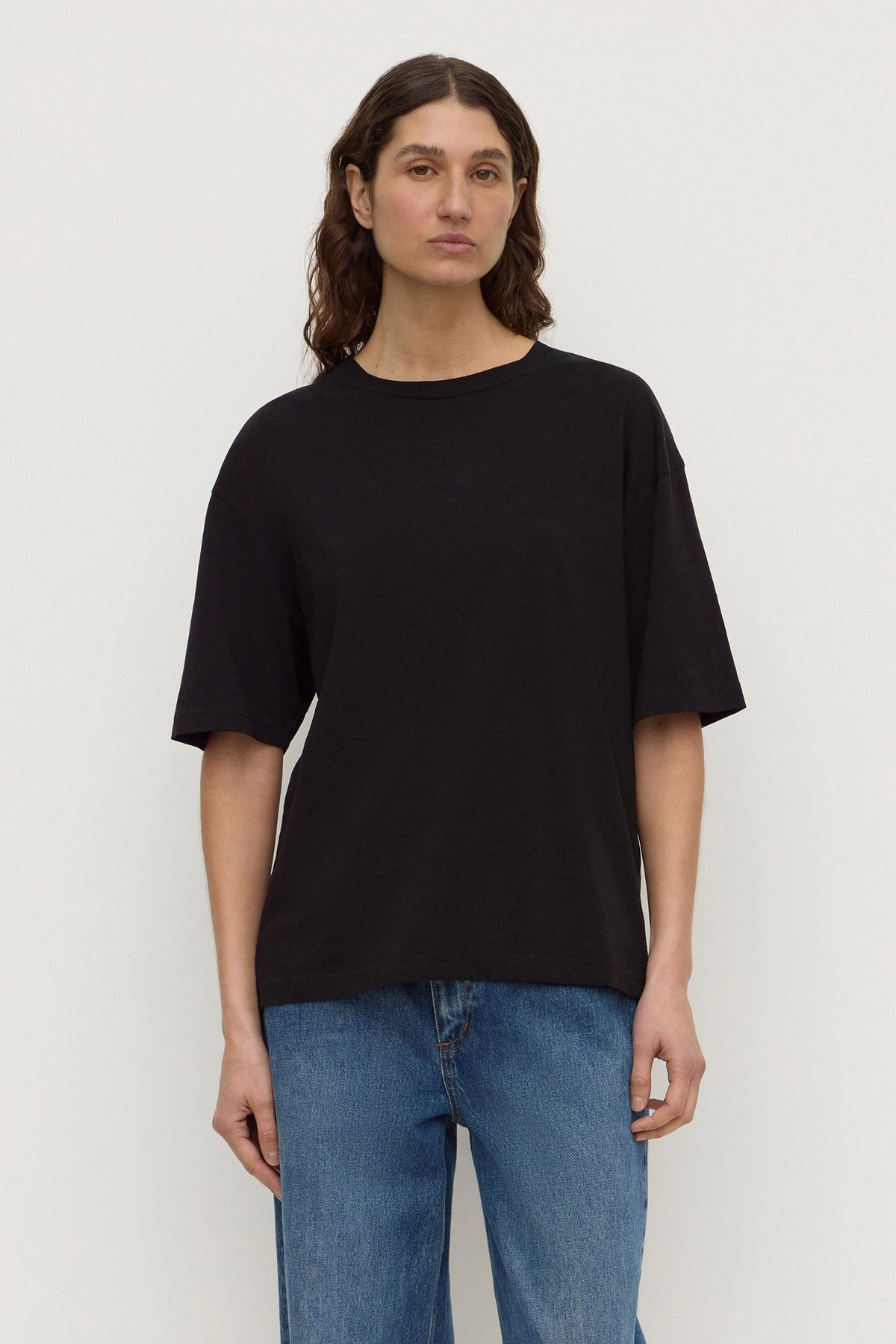 A Cotton Hemp Tee in black shown from the front with a relaxed boxy fit and short sleeves.