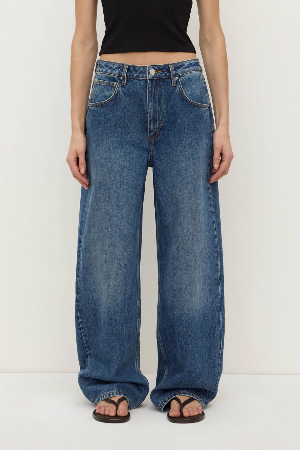 Assembly Label Low Curve Jeans in Mid Blue — the Assembly Label Low Curve Jeans in Mid Blue offer a relaxed take on everyday denim with a contemporary curved-leg silhouette.
