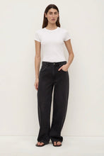 Person wearing a white t-shirt and black pants on a white background