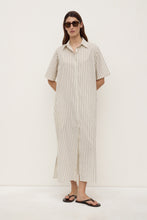 Model wearing the striped midi shirt dress with sunglasses and black sandals, showing the relaxed fit, button-through front and straight midi-length hem, full-length front view
