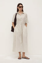 Model wearing the striped midi shirt dress with sunglasses, black shoulder bag and sandals, showing the waist tie, short sleeves and relaxed silhouette, full-length front view
