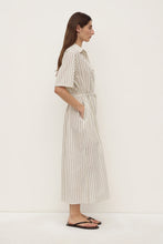 Model wearing the striped midi shirt dress with black sandals, showing the side seam pocket, waist tie and relaxed midi silhouette, full-length side view
