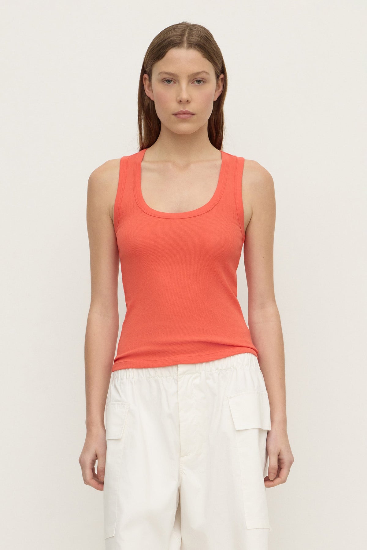 A model wears a dahlia rib tank with a scoop neckline and fitted silhouette in a front view.