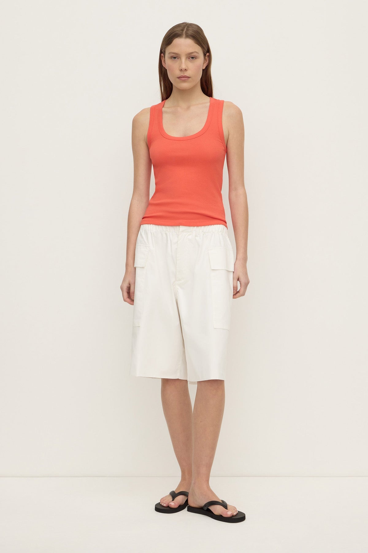 A model wears the dahlia rib tank with white cargo shorts in a full front view.
