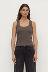 Model wearing the bark rib tank with washed black jeans, showing the scoop neckline, wide shoulder straps, fitted silhouette and hip-length hem, front view
