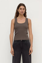 Model wearing the bark rib tank with washed black jeans, showing the scoop neckline, wide shoulder straps, fitted silhouette and hip-length hem, front view
