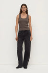 Model wearing the bark rib tank with washed black jeans and black shoes, showing the scoop neckline, close-to-body fit and sleeveless silhouette, full-length front view