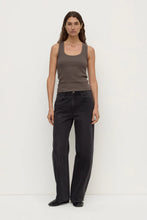 Model wearing the bark rib tank with washed black jeans and black shoes, showing the scoop neckline, close-to-body fit and sleeveless silhouette, full-length front view