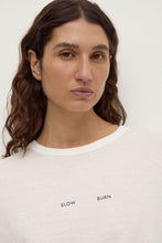 Assembly Label Slow Burn Wide Sleeve Tee in Antique White, close-up showing the ribbed neckline and Slow Burn graphic.
