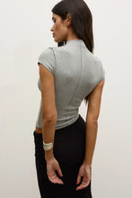 Model wearing a Grey Marle fitted cap-sleeve mock-neck top with a black maxi skirt, showing the centre-back seam and body-hugging fit, back view