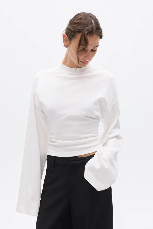 Bayse Brand Lex Long Sleeve in White — a refined update to a classic everyday essential, the Bayse Brand Lex Long Sleeve in White features a relaxed silhouette, dropped shoulders and a slightly cropped length.