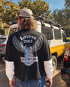 dDARL Lovers Layered Tee in Black, worn from behind by a man on a street, showing the eagle back graphic