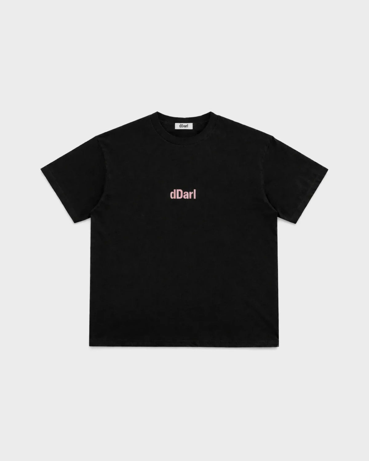 dDARL Puff Tee in Black, front flat lay with pink puff logo