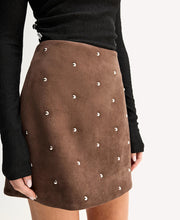 Close-up of the Mocha Elka Collective Avenue Mini Skirt showing the rich suede-effect texture and all-over polished silver-tone dome stud embellishment
