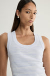 A close-up of a pale blue marled sleeveless knit top showing its rounded scoop neckline, ribbed neckline trim and fine textured knit across the upper chest.