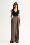 Elka Collective Fleur Pants in Taupe, full-length front view on model.
