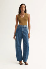 Model wearing the moss Hayes Knit with blue wide-leg jeans and sandals, showing the fitted shape, scoop neckline and ribbed texture, full-length front view