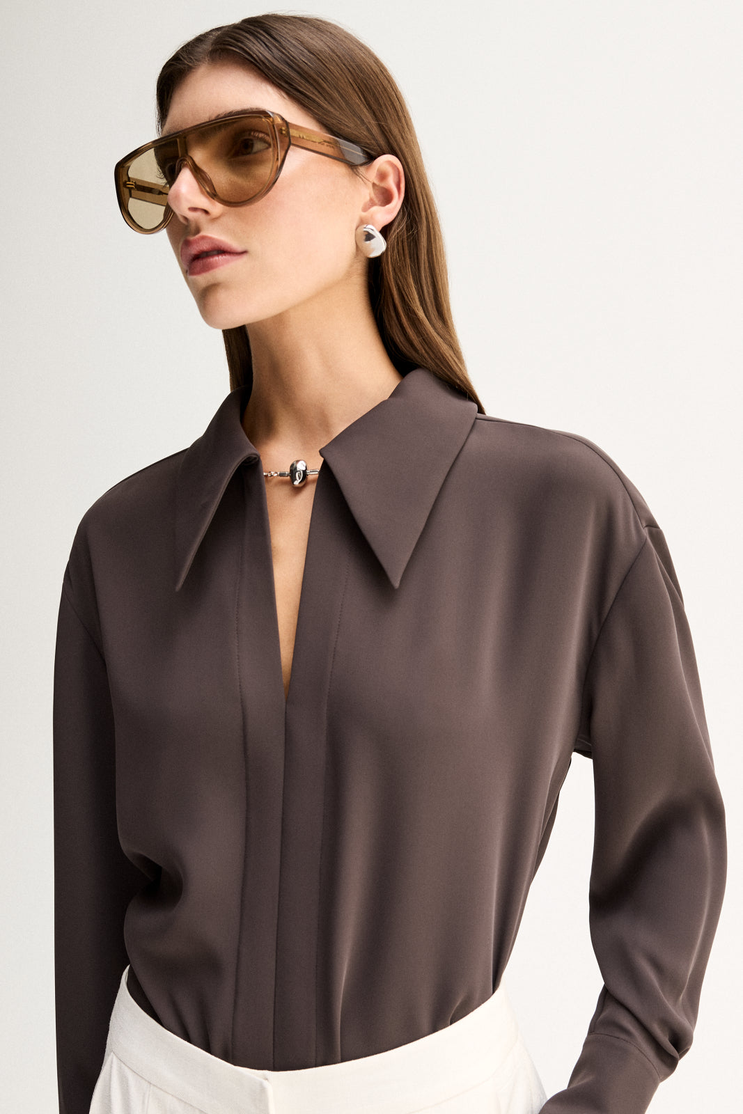 Close-up view showing the slate shirt's collared neckline, keyhole detail and fluid fabric.