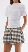 Elka Collective Roxie Top in White, front view on model with gathered waist detail.